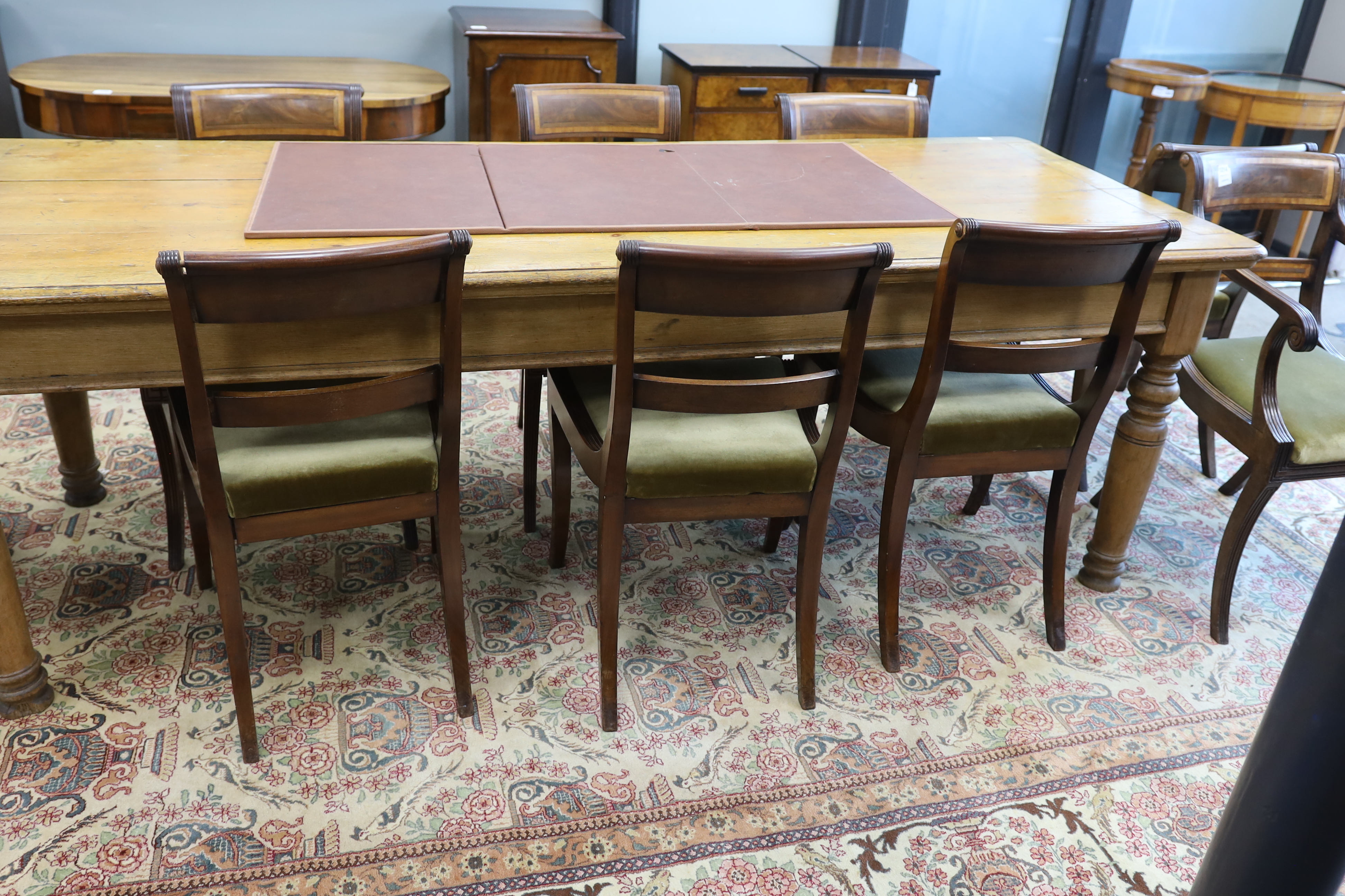 A set of eight Regency mahogany and satinwood banded sabre leg dining chairs, two with arms